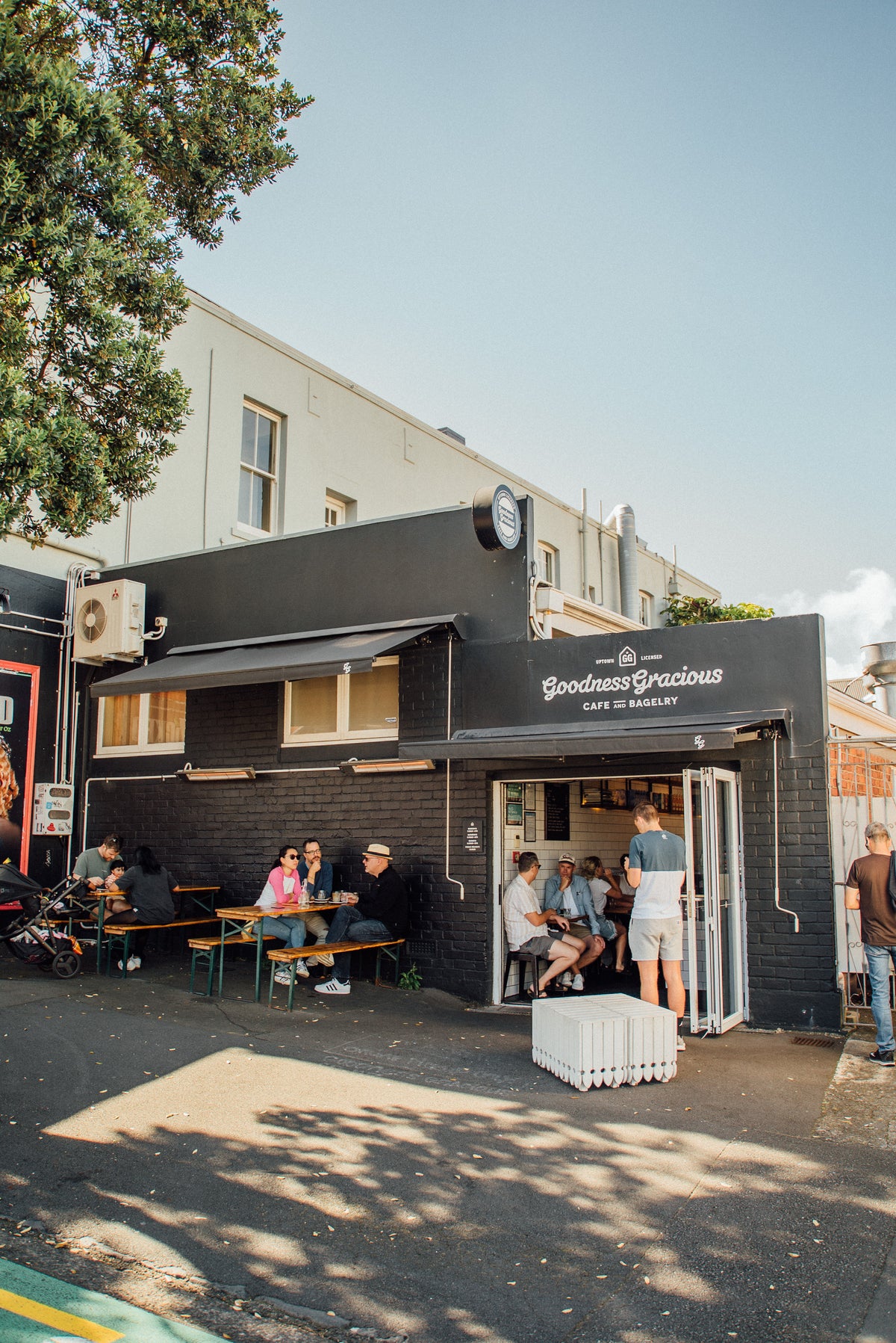 The Goodness Gracious shopfront on New North Road, Eden Terrace, with customers on the benches outside